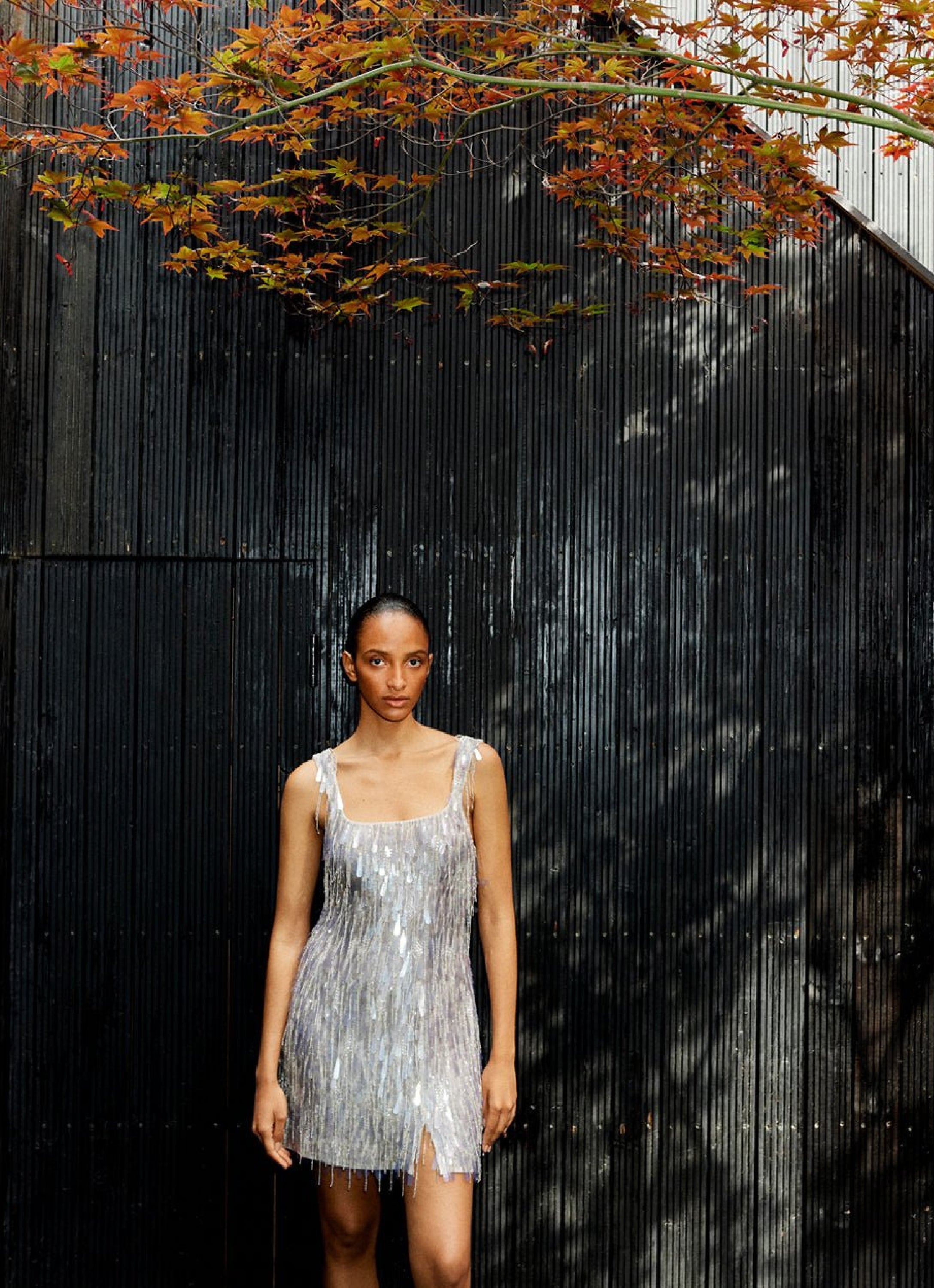 A woman standing under a tree, wearing one of Ilta Studio's best selling dresses--Zuki